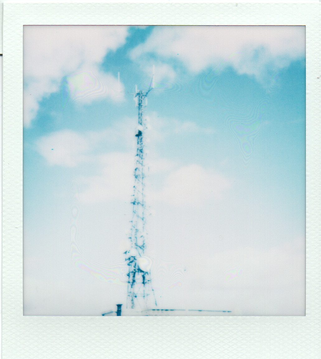 a radio tower against a blue sky